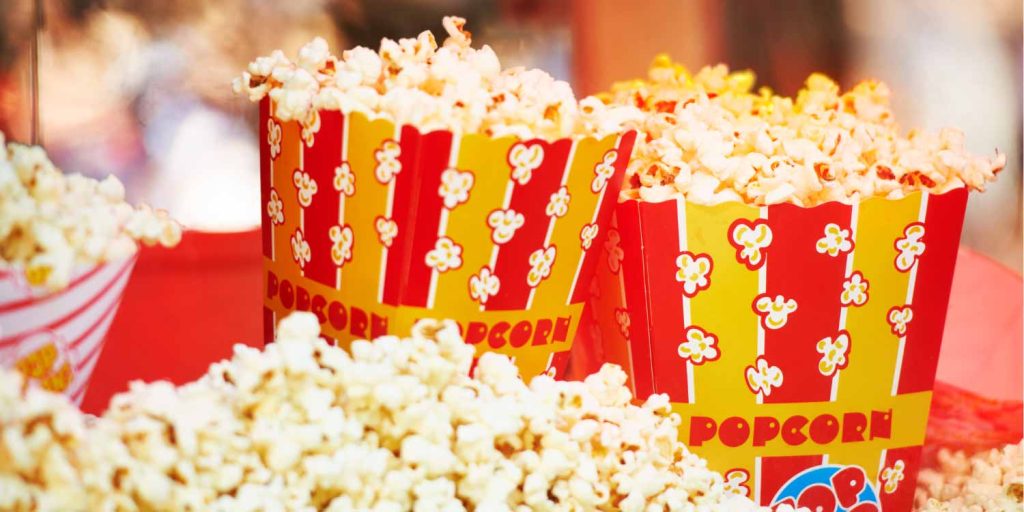 Closeup of movie theater popcorn that is on the list of foods to avoid with braces